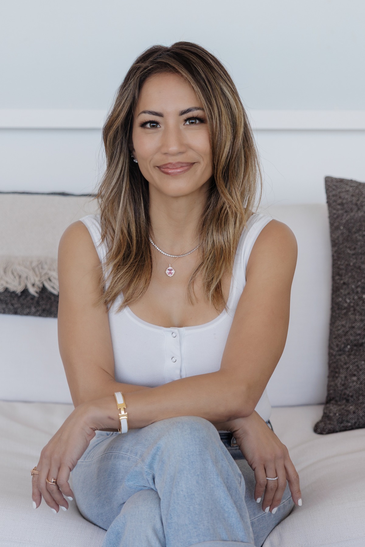 Jacqueline seated in a white top